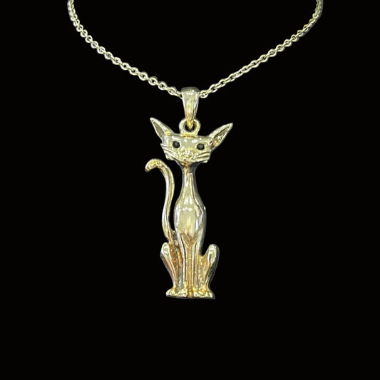 Gold cat-shaped pendant on a chain against a dark background